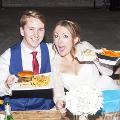 Wedding couple enjoying urban food fest street food